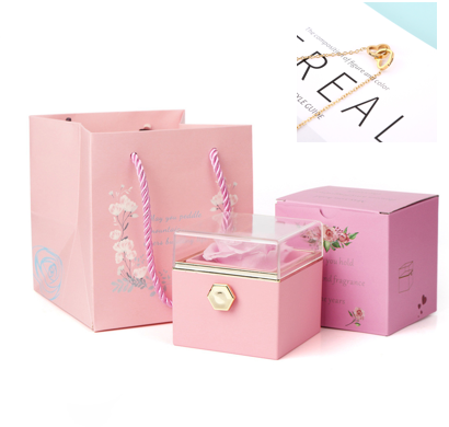 Heart-shaped necklace and rotating rose jewelry box