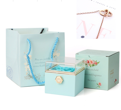 Heart-shaped necklace and rotating rose jewelry box